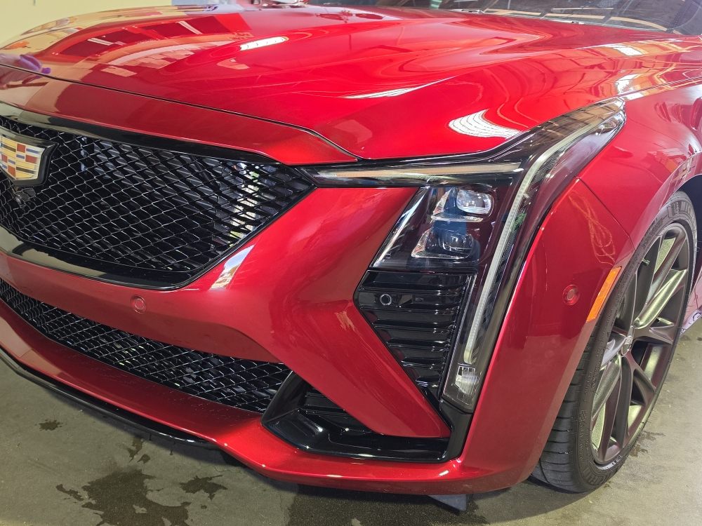 Red Cadillac V-Series front end in the shop