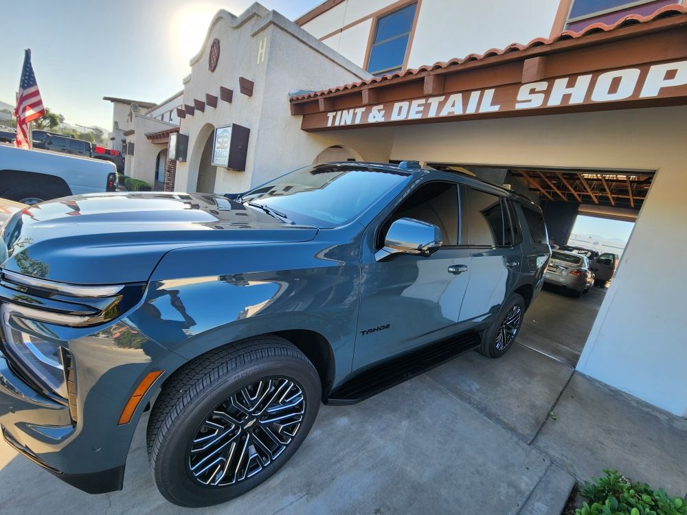 Cadillac Escalade with fresh tint outside the shop bays