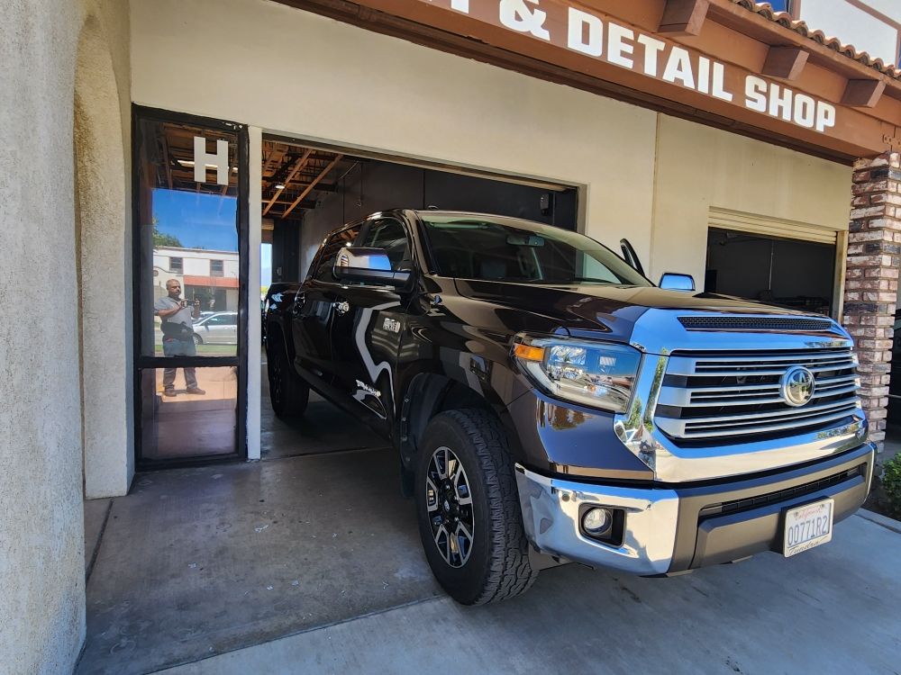 Black Ford F-150 in front of the Tint & Detail Shop bay