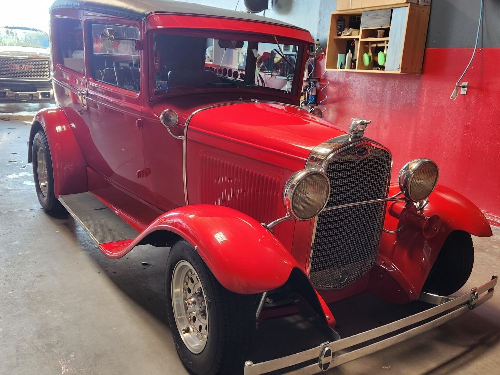 Classic red hot rod detailed in the shop