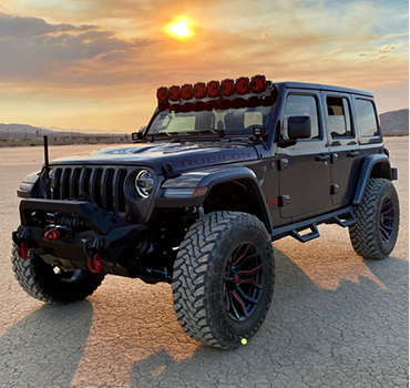 Lifted Jeep Wrangler on desert flats at sunset after a full detail