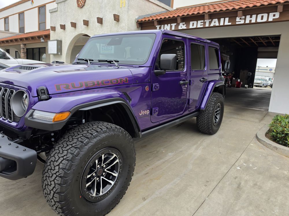 Purple Jeep Wrangler outside the Tint & Detail Shop