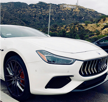 White Maserati Ghibli detailed by the shop, parked below the Hollywood sign