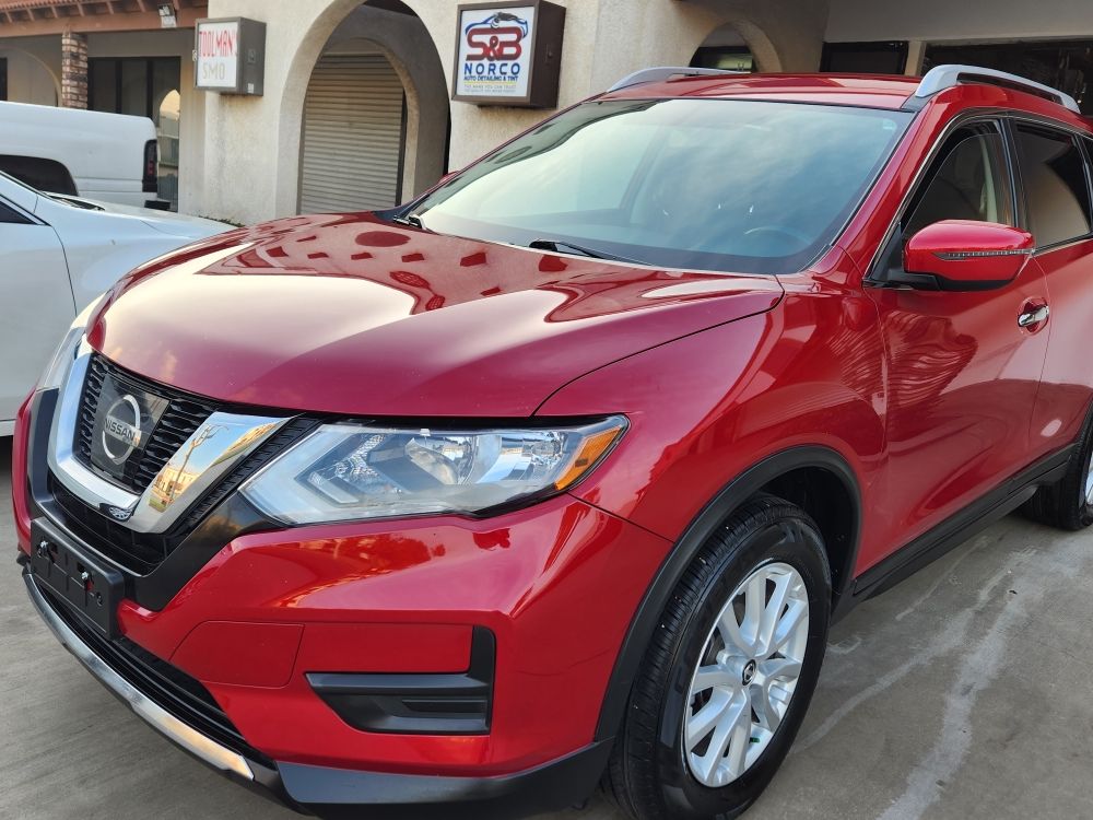 Red Nissan Rogue freshly detailed