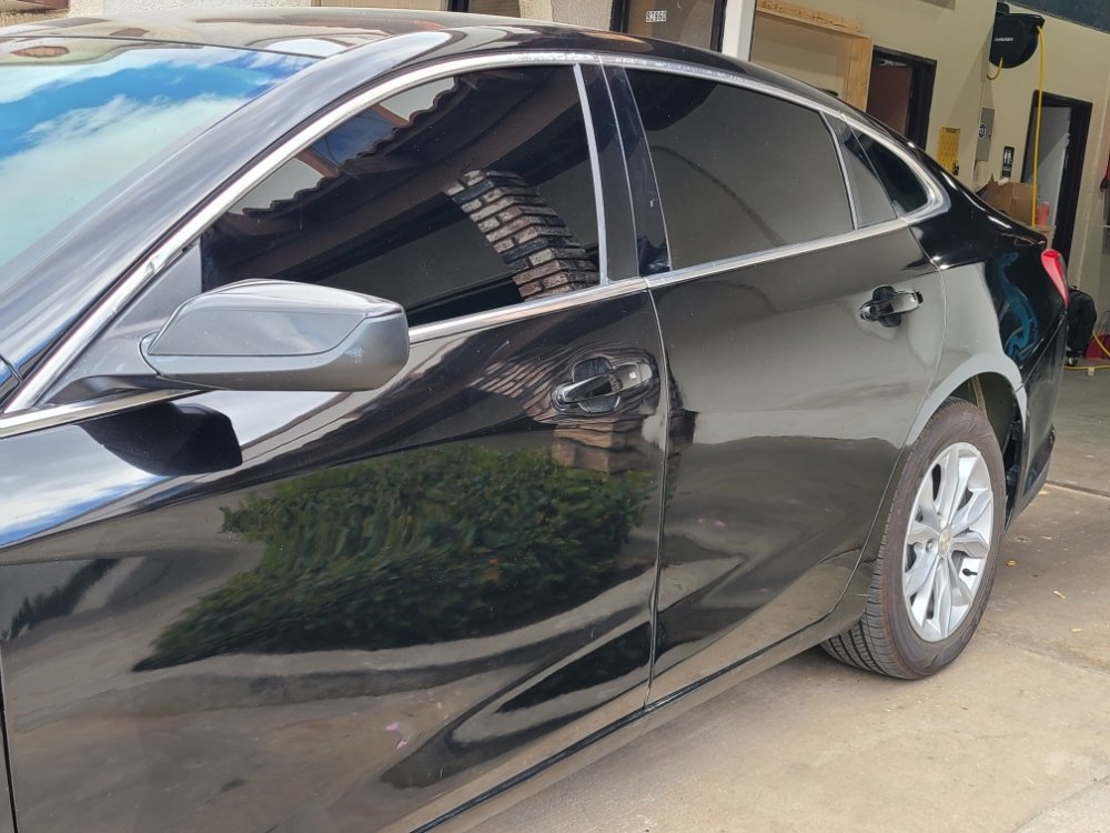 Black sedan with fresh tint outside the shop