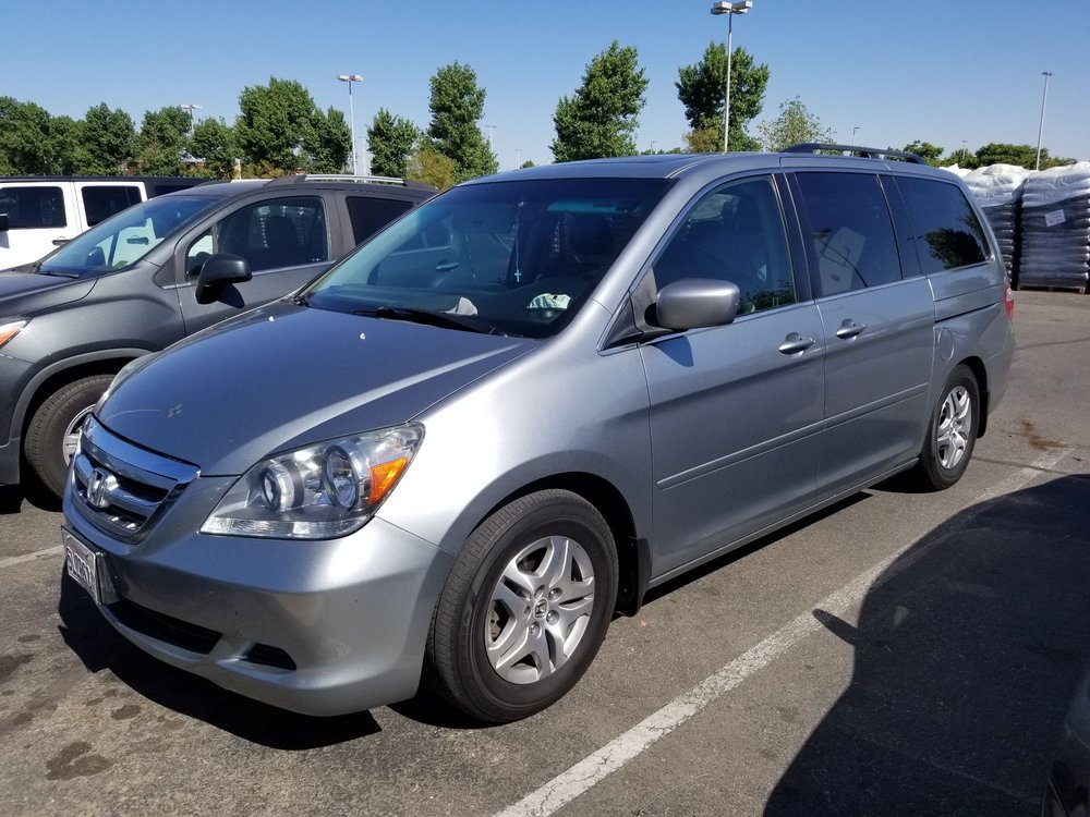 Silver minivan outside the shop