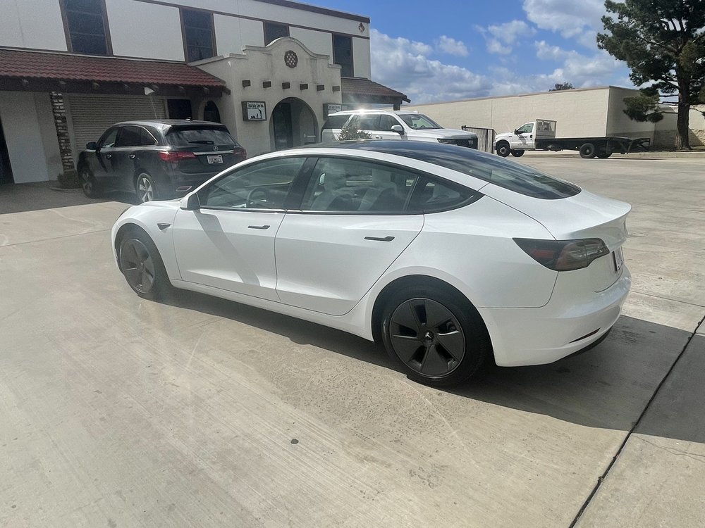 White Tesla Model Y outside the shop
